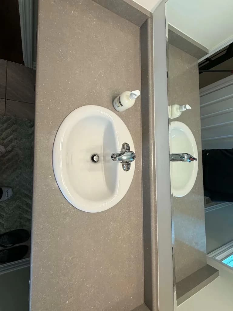 Clean bathroom vanity sink with polished chrome faucet
